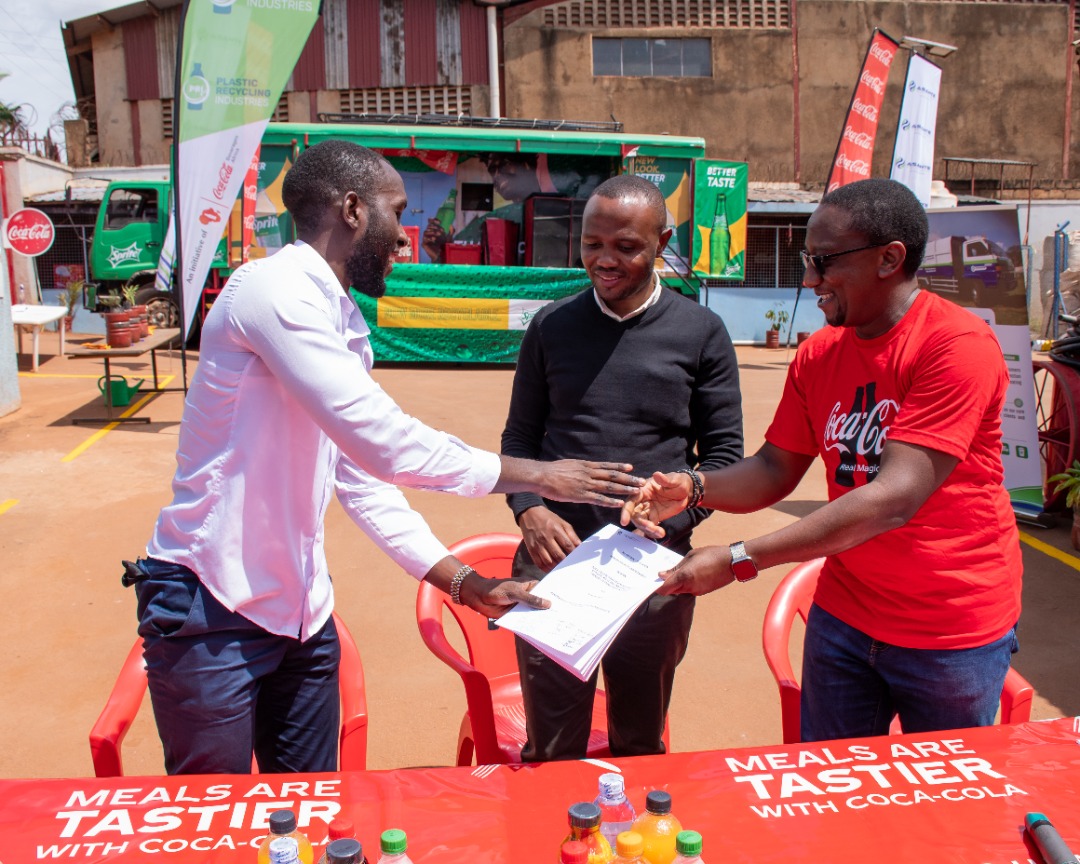 Kirunda Magoola, Public Affairs & Communication Director at CCBA handing over the MOU to Rogers Kibule, Marketing Manager, Yo-Waste Limited at Plastic Recycling Industries