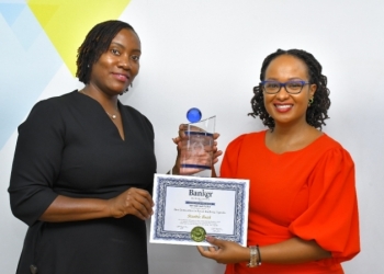 Caption: Stanbic Bank’s Head of Customer Solutions Miriam Naigembe (left) and Sonia Karamagi, Manager—Customer Experience pose with the Best Innovation in Retail Banking International Award.