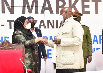 President Museveni shares a light moment with Tanzanian President, Samia during the 22nd Ordinary Summit of Heads of State in Arusha, Tanzania (PHOTO /Courtesy)