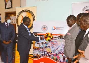 Finance Minister Matia Kasaija (left) and Uganda Debt Network Board Chairman Fred Omach at the launch of the budget survey.