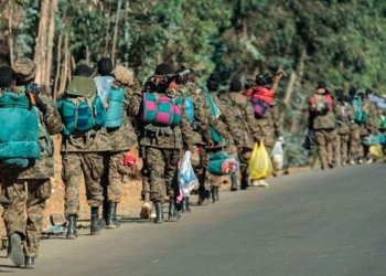 Ethiopian National Defense Force soldiers walk along a road on December 6, 2021