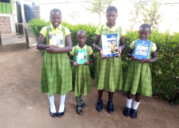 Bridge Schools Uganda pupils with books