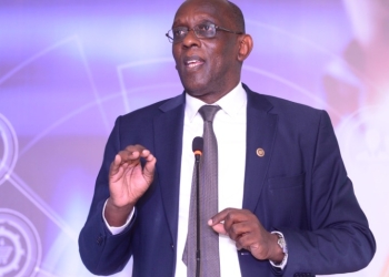 Dr. Ham Mukasa Mulira, the Senior Presidential Advisor on ICT gives his remarks at the Launch of ProMISe ERP. ProMISE ERP, a system that swiftly digitizes and automates business processes (PHOTO/Courtesy).