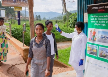A health worker during temperature screening at Gatuna One Stop Border Post on May 27, 2019. All travellers entering Rwanda from Uganda are now subject to screening following an outbreak of Ebola Virus Disease in Uganda.