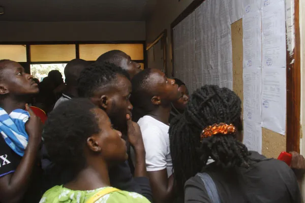Students look at lists displayed on a noticebaord (PHOTO/Courtesy)