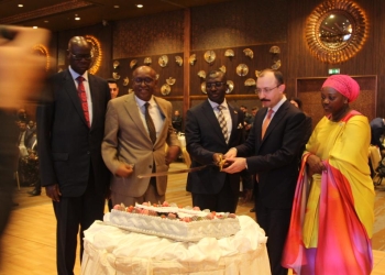 John Mulimba, Uganda's Minister of State for Foreign Affairs in charge of Regional Cooperation and Mehmet Muş, the Turkish Minister of Trade of Turkeywith Nusura Tiperu Omar, Uganda's Ambassador-Designate toTurkey cut the cake to officially commemorate the 60th Independence celebrations