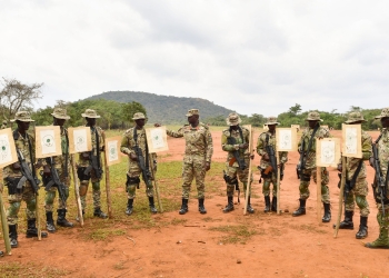 Col JB Asinguza (C), the Director of Training in SFC inspects the targets shot by the soldiers during a passout at Kaweweta on Wednesday upon finishing their Tier II Course. (PHOTO/ PPU)