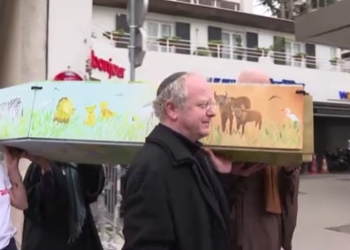 These religious figures arrived carrying an empty coffin with African landscapes painted on it.