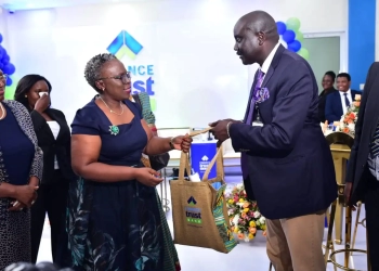 Dr. Evelyn Kigozi Kahiigi, the Finance Trust Bank Board chairperson gifts Dr. Tumubweinee Twinemanzi, the Executive Director of Supervision at the Bank of Uganda who presided over the launch of new corporate head offices