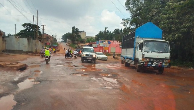 Vehicles navigate potholes along Sir Apolo Kaggwa road. URN photo