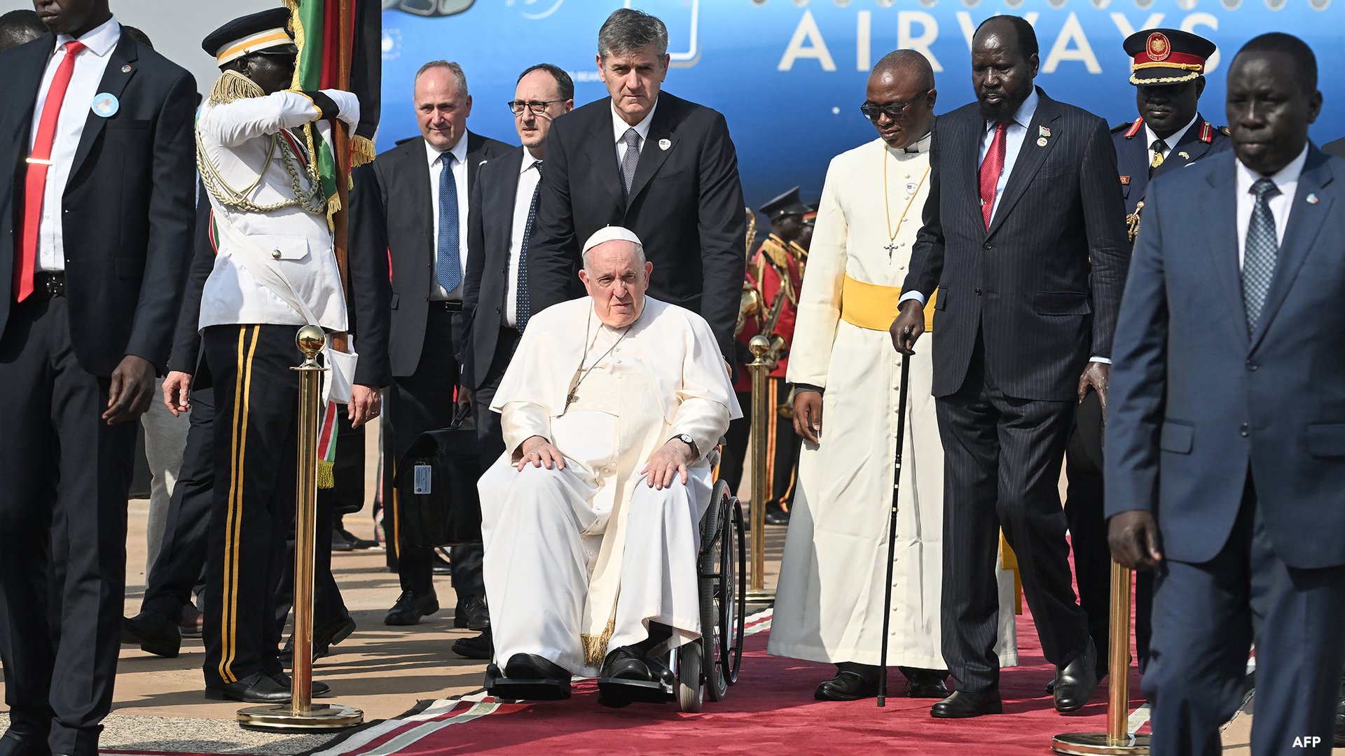 South Sudan President Salva Kiir walks next to Pope Francis upon the pontiff's arrival at the Juba International Airport in Juba, South Sudan, on Friday.