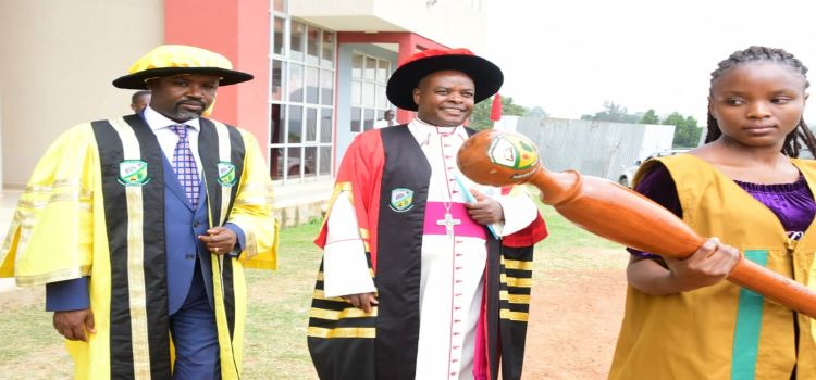 A student (right) leads the Deputy Speaker, Hon. Thomas Tayebwa (left) and the Chancellor of the University of Saint Joseph, Mbarara City, His Grace, Lambert Bainomugisha, to the 2nd graduation ceremony on Saturday, 18 February 2023. The Deputy Speaker tipped private universities on growth