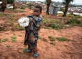 A child holds a pan of locusts at a camp for internally displaced persons in the Democratic Republic of the Congo. Image source: UNICEF/Olivia Acland