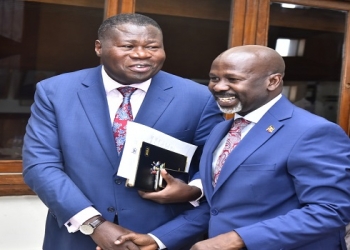 Hon. Oboth Oboth (L) interacts with Kasilo County MP, Hon. Elijah Okupa after the meeting
