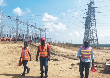 Ugandan employees of China International Water & Electric Corp in front of the switchyard of Isimba hydropower station. The project site is about 21km from Kayunga Town
