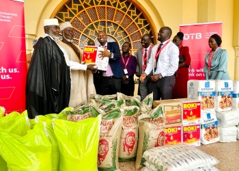 DTB staff led by Andrew Musanje, the Head of Branches (3rd left) handing over food items to the Muslim Grand Mufti of Uganda, Sheikh Shaban Mubaje Ramadhan