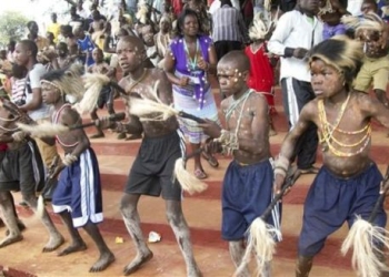 Bugisu candidates wearing skins of colobus monkey dance in preparation for circumcision
