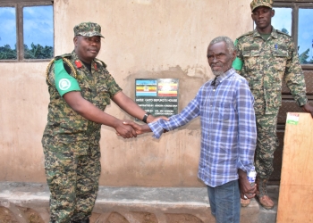 Col Michael Walaka Hyeroba-the UPDF Contingent Commander handing over the house to mzee Ghato Sefuka