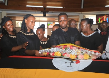 Justice Amoko's Children laying a wreath on her casket during the Requiem mass held on Wednesday (Photos by Judiciary)