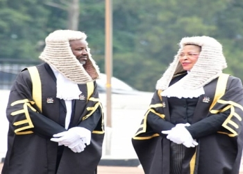 Speaker Anita Among (R) with her deputy Thomas Tayebwa as they waited to receive the Vice President, Jesca Alupo