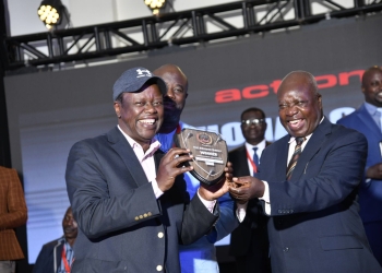 Prof Waswa Balunywa receiving his plaque on Tuesday evening at Hotel Africana.