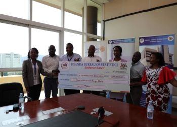 UBOS Staff and Rotary Club of Bugolobi leadership displaying the dummy cheque at the hand over ceremony on Friday.