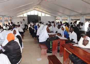 Crowded senior one class attending lessons in one of the tents in Bukonde SS