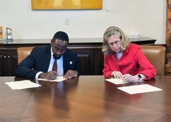 His Majesty and President Wintersteen sign their names on the MOU document inside the President's office in Beardshear Hall.