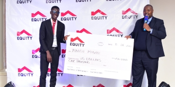 Yunus Mugabe receives a dummy check of USD1000 from MD Equity Anthony Kituuka (PHOTO/Courtesy)