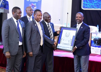 Deputy Speaker Thomas Tayebwa receives a portrait from transport minister Katumba Wamala (PHOTO/Courtesy)