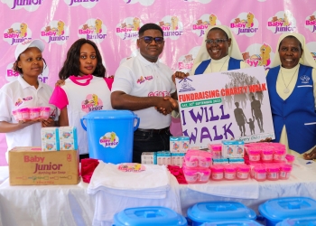 Steven Mukisa from Movit handing over the donation to Sister Maria Teddy Nakyanzi from Nsambya Babies Home.