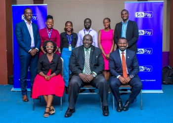 (Seated, left-right), Charity Atukwatsa Mutagamba, the CEO, Fincom Technologies Ltd, George Mutekanga, the Assistant Commissioner In Charge Of Private Schools And Institutions at the Ministry of Education and Sports, Mathias Kamugasho, Managing Director, Service Cops Ltd together with company staff.
