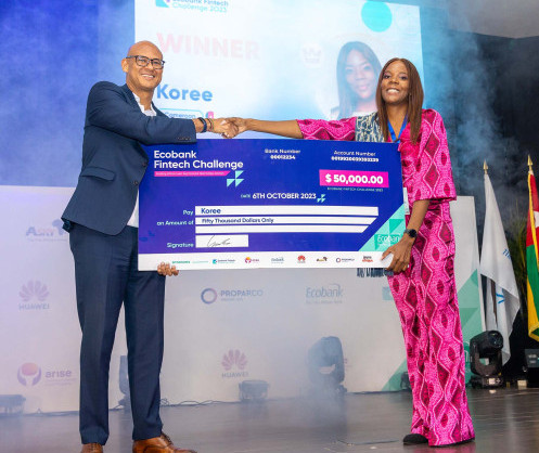 Ecobank's Group CEO, Jeremy Awori, hands over the grand prize of US$50,000 to winner Koree from Cameroon