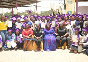 (L-R Seated) Maria Kizito, Area education inspector, Kasangati Town Council, Catherine Namara, Team Lead, Women at Work at MTN Uganda, Smart Girls Foundation CEO Jamila Mayanja, Enid Edroma, General Manager, Corporate Services at MTN Uganda, and Michael Okumu, the deputy director-in-charge of assessment and certification at DIT join graduands for a group photo during the inaugural graduation of MTN Girls in Tech Program.