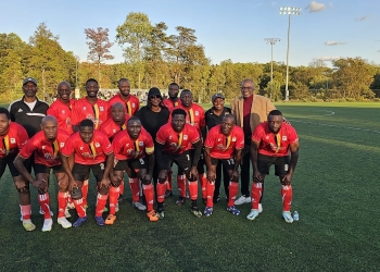 Amb. Kakonge poses with the DMV Cranes at the friendly soccer match with Liberia