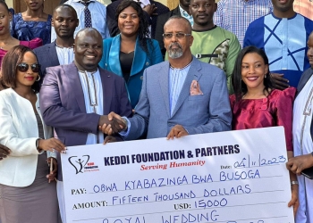 Officials from Keddi Foundation handing over a dummy cheque to some members of the Royal Wedding organizing committee.