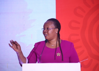 Hon. Sarah Nyirabashitsi Mateke , the  t
state Minister for Youth and children address participants at the symposium.