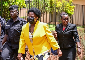 Minister Hon Gorretti Kituttu being accompanied to court by Police officers few months back (courtesy photo)