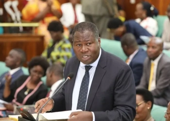 Minister Jacob Oboth presenting his statement on passports to the House