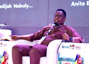 Timothy Opobo, the Executive Director of Afri Child Uganda addressing the gathering at the symposium.