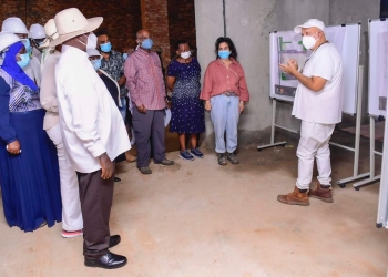 Tycoon Sudhir Ruparelia explains the processes to President Museveni last week.