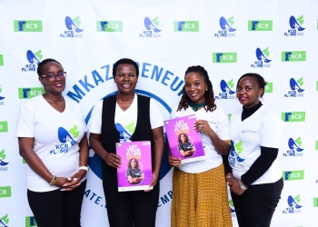 Agnes Mayanja Namyalo, (2nd L), KCB Bank Executive Director and Immy Nakyeyune, (2nd R), Founder and Leader at Mkazipreneur pose for a photo with other KCB Bank staff members during the partnership event at Mkazipreneur offices in Kampala