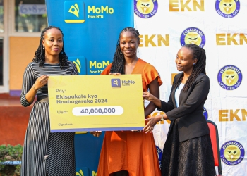 MTN MoMo's Manager Regulatory and Corporate Affairs, Patricia Nabasirye handing over the UGX 40m cheque to HRH Sarah Katrina Ssangalyambogo at the Hormisdallen School-Gayaza