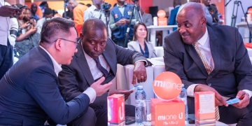 The Managing Director, Mione, Ben YU, shares a moment with the The Minister of Information, Communications, Technology and National Guidance, Hon. Dr. Chris Baryomunsi, and the State Minister of Trade and Cooperatives, Hon David Bahati, at the launch of U1 and Joy 9 phones.