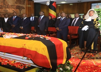 Speaker Among (R) and other MPs pay their respects as Cecilia Ogwal's body lies in the foyer of Parliament
