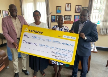L-R: Dennis Mbiika (Head of Sales Letshego), Sister Sarah Kasya Tumuhimbise (Deputy HM MaryHill), Fortunate Atuhaire (Letshego bursary recipient 2024) & Hon Francis Mwijukye (MP Buhweju) unveil and display UGX20m education bursary from Letshego for 4years at MaryHill High School Mbarara.