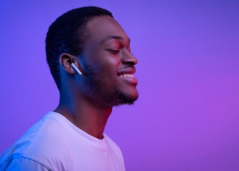 Relaxed African American Man Listening to Music in Wireless Airpods