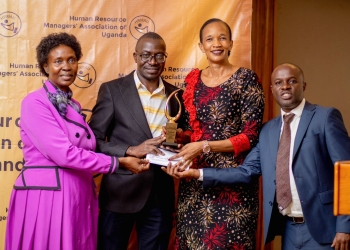 Minister Esther Anyakun(in Kiteng ), Hon Margaret Rwobushaija (in pink dress) and HRA-U President Ronald  Bossa handing over the plaque to one of the outgoing members of the General Council on Friday at Serena Hotel Kampala