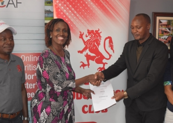 (R-L) Moses Turyagumanawe, Marketing Manager at Unicaf University Uganda, Suzan Muhoza, First Vice President of Old Budonian Club at OBC, shake hands after formalizing their partnership
