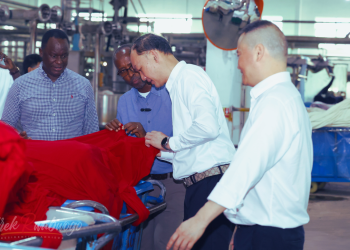 Mr Yang Qian Senior Consultant CNlight Technology limited explains to Odrek Rwabwogo the dying processes n texting factory of Kam Hing